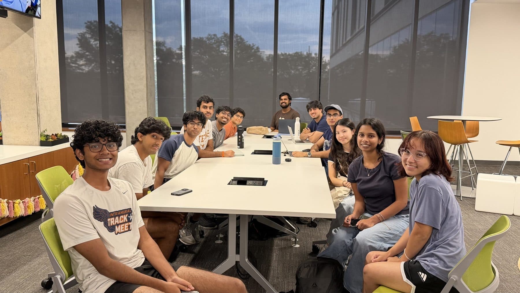 The design verification team seated around a table in EER