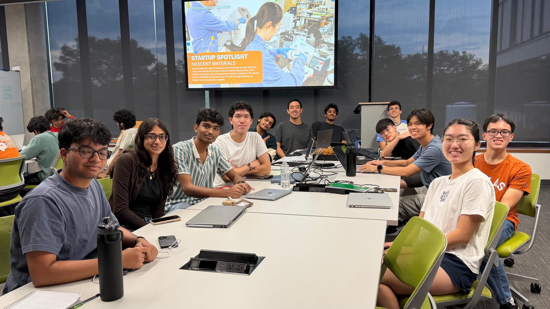 The RTL team seated around tables in EER on a Sunday workday, smiling at the camera